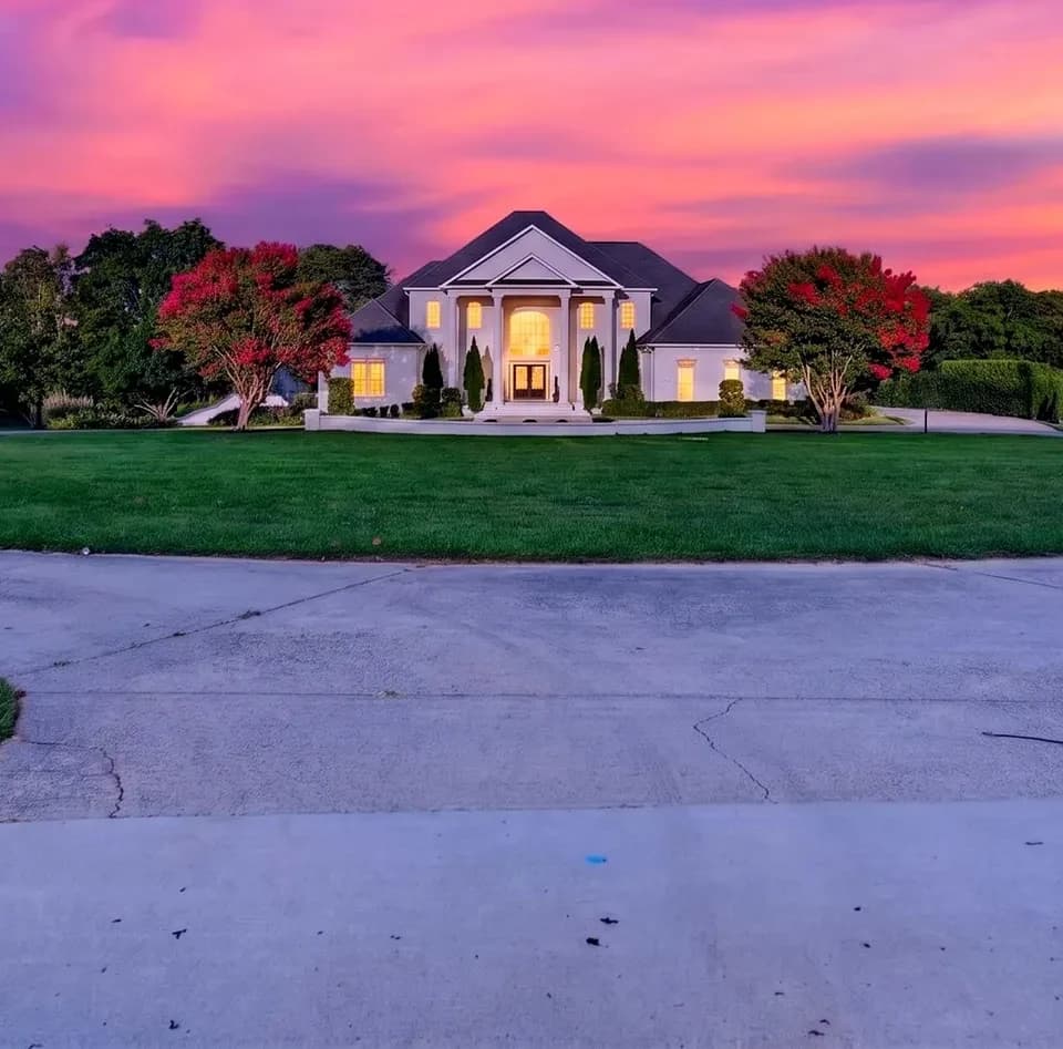 White Fallow Estate mansion at twilight under a pink Georgia sky