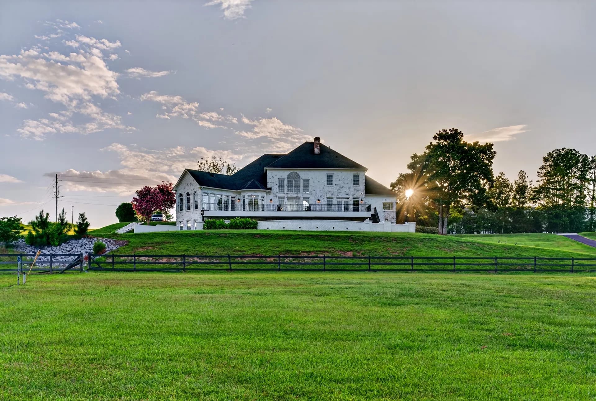 Rear exterior of the mansion at sunset