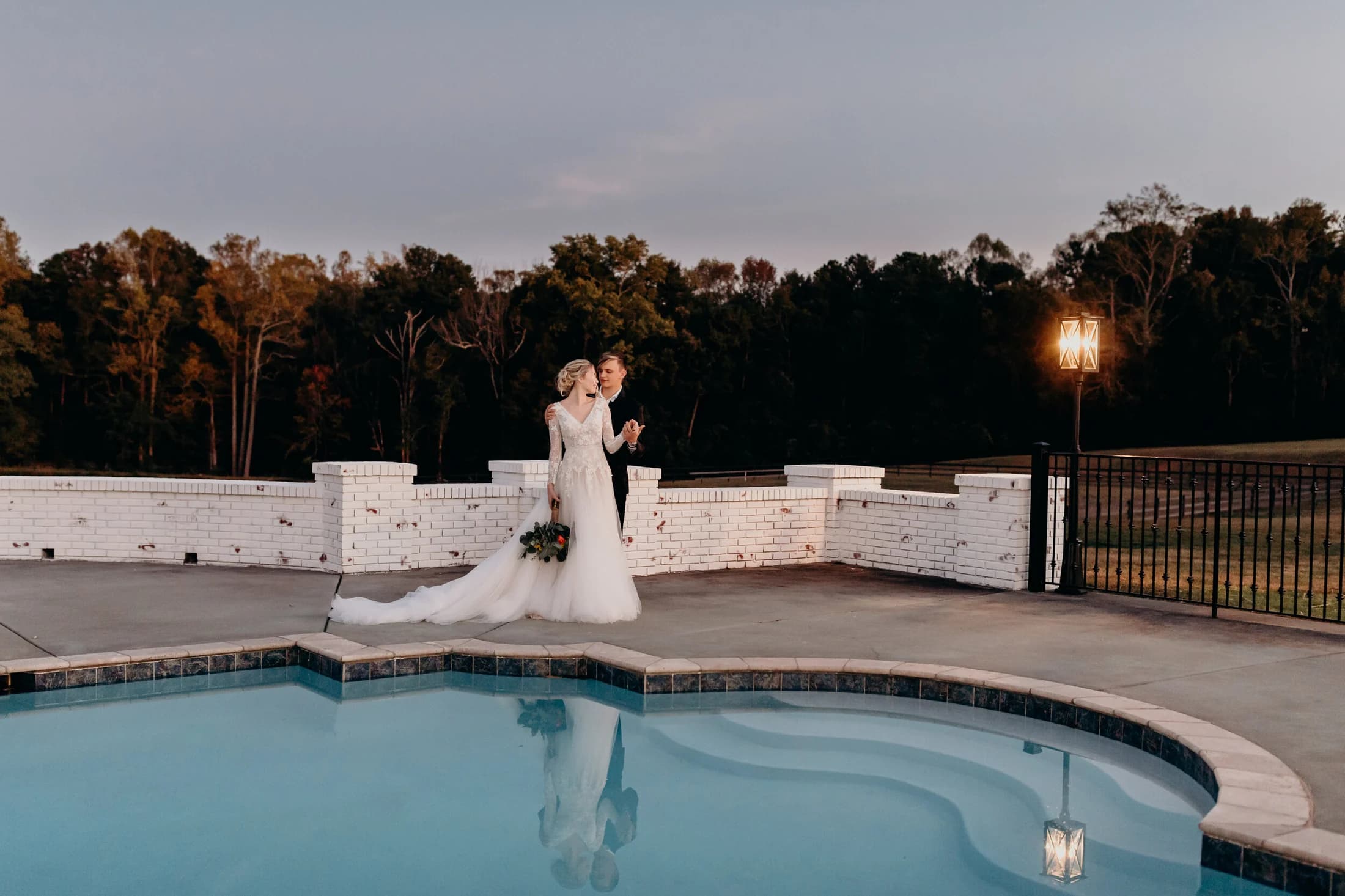 A couple by the pool at golden hour